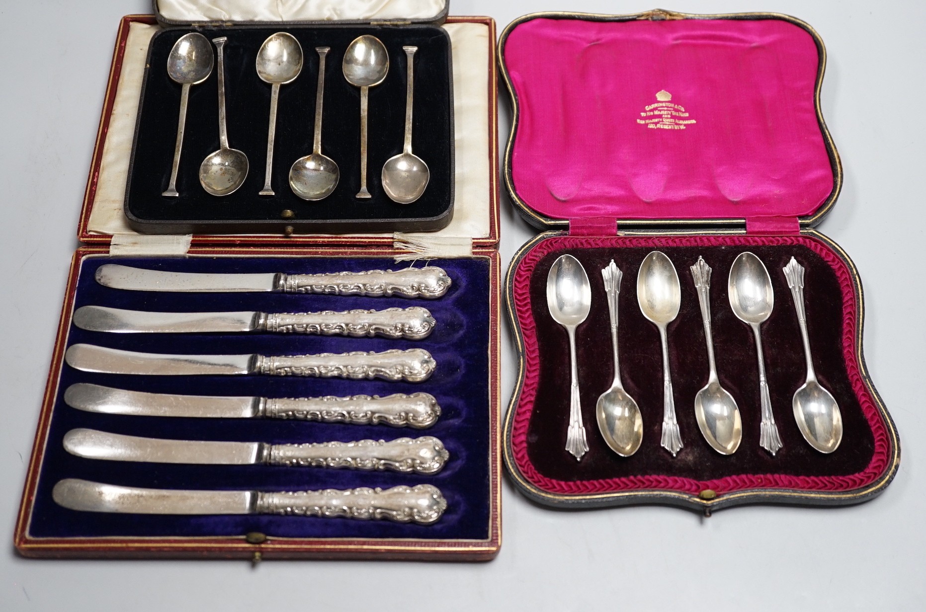 A set of six teaspoons, London, 1910, a set of six silver coffee spoons, six silver handled tea knives, all cased.